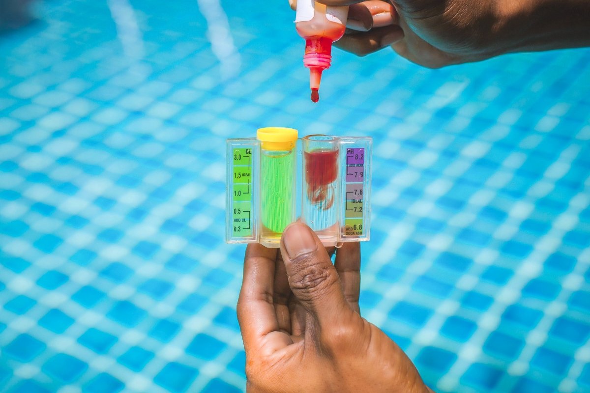 Action of a person hand is using Phenol red droplet to drop into sample water for measuring the pH value.