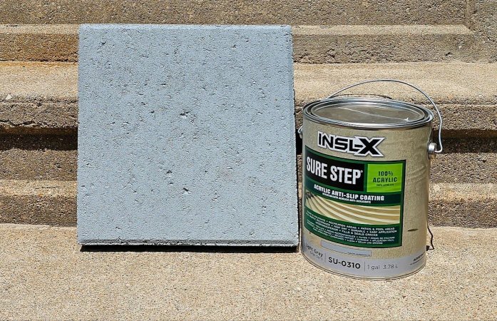 A gallon can of Benjamin Moore INSL-X paint next to a cement block during testing.