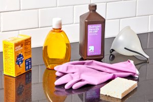 Materials and tools needed to create homemade grout cleaner.