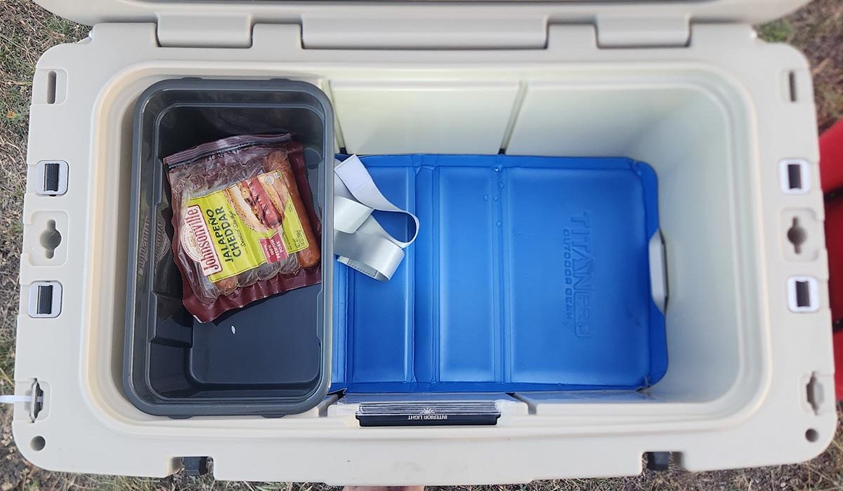 Inside of a white Titan 55 quart cooler with blue plastic storage containers