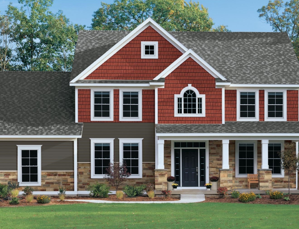 A large home with different colored siding.