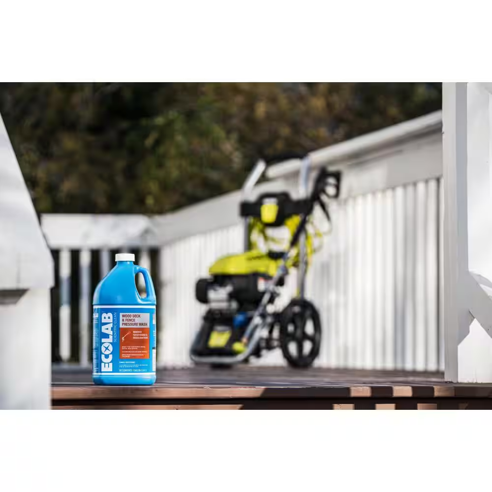 Ecolab deck cleaner on a deck with a pressure washer in the background.