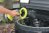 Person using Ryobi Power Scrubber to clean back of camper