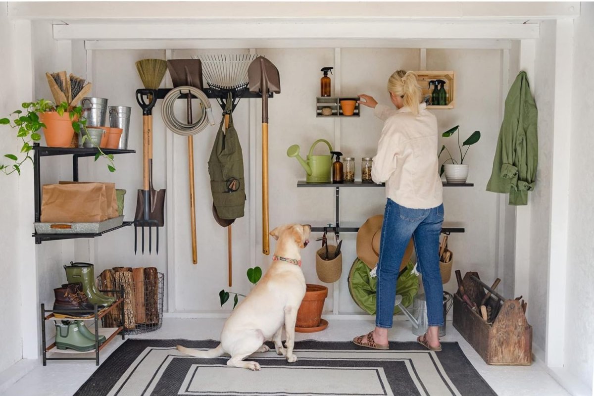 a woman arranging tools in StoreYourBoard BLAT Garden Tool Organizer