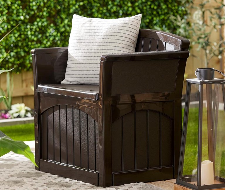 Suncast 31-Gallon Outdoor Patio Seat, brown, with throw pillow, on an outdoor patio
