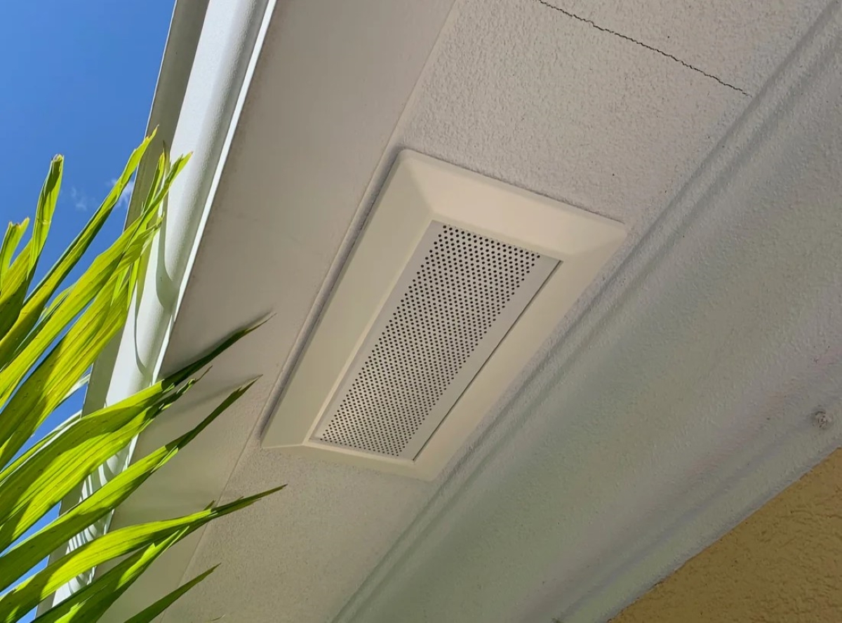 Attic ventilation soffit installed underneath ridge of the roof.