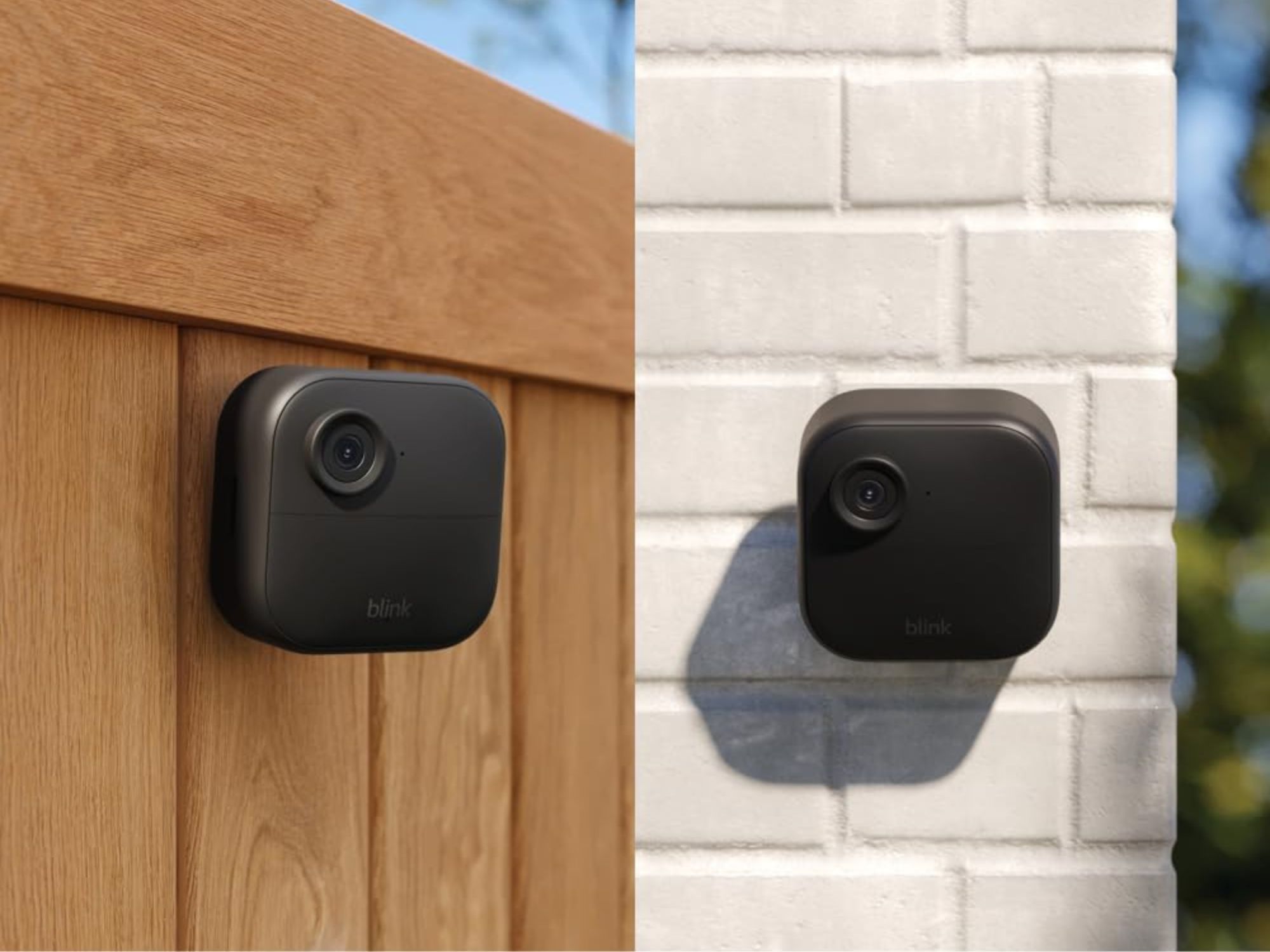 Two Blink Sync XR cameras, one mounted on white brick and one mounted on wood fence