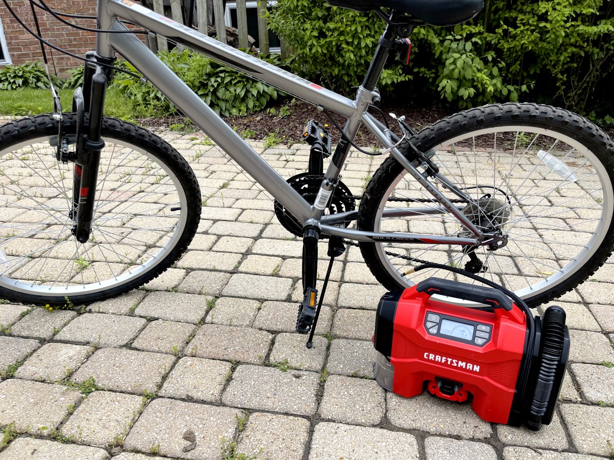 Craftsman 3-in-1 Cordless Inflator reinflating a bike tire