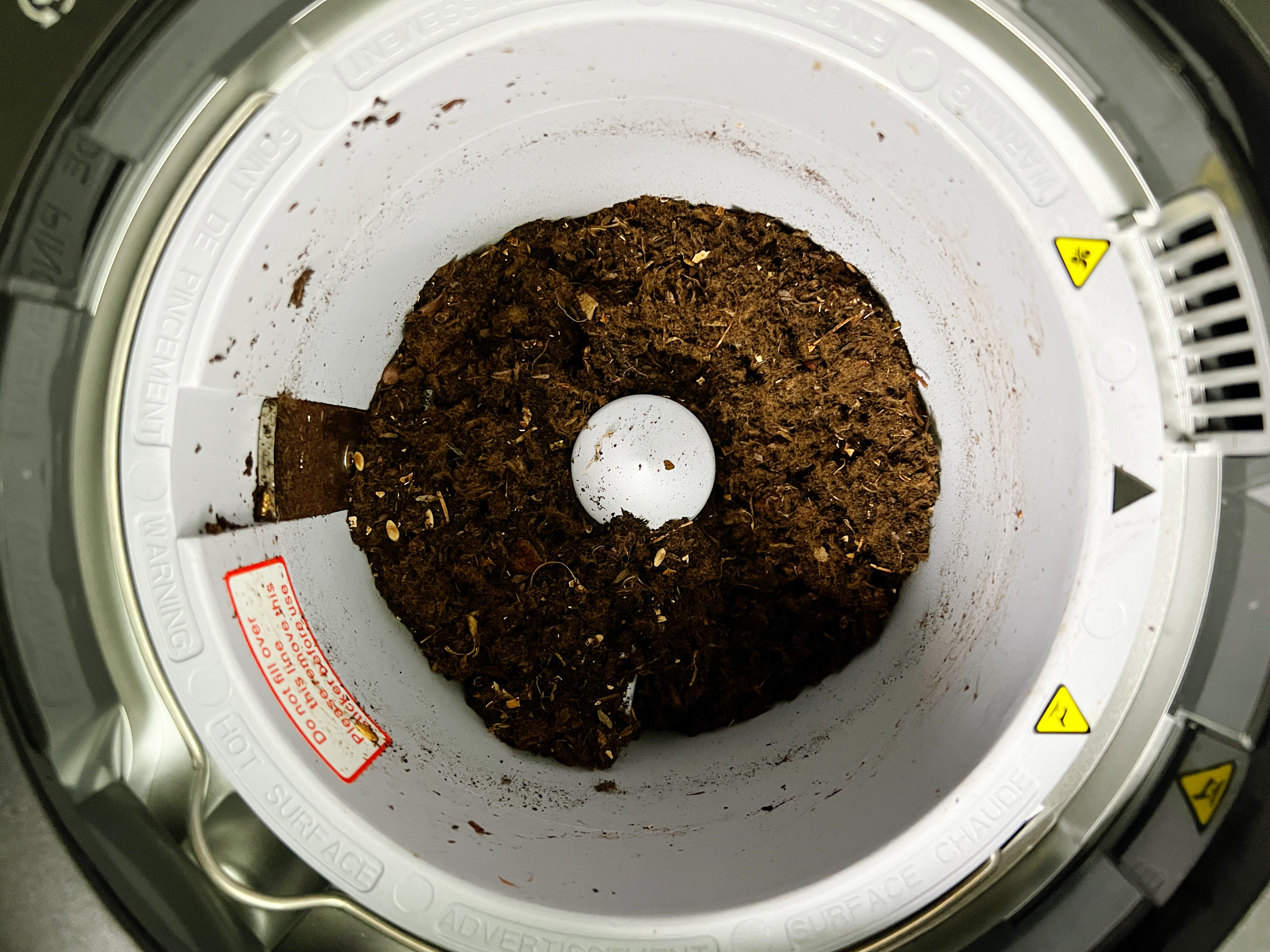 Inside of Vego kitchen composter with finished compost