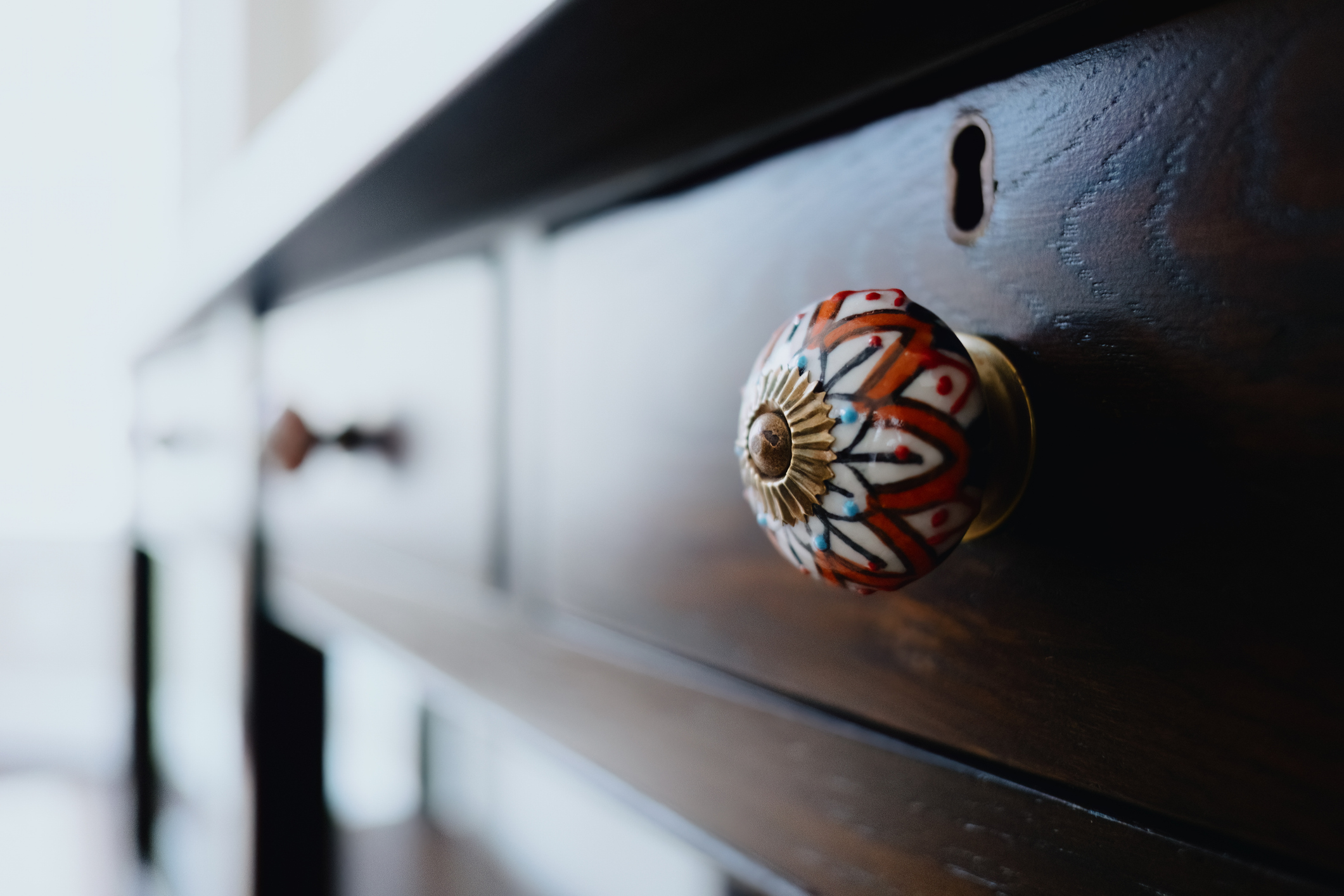 Close-up of decorative knob on table drawer.
