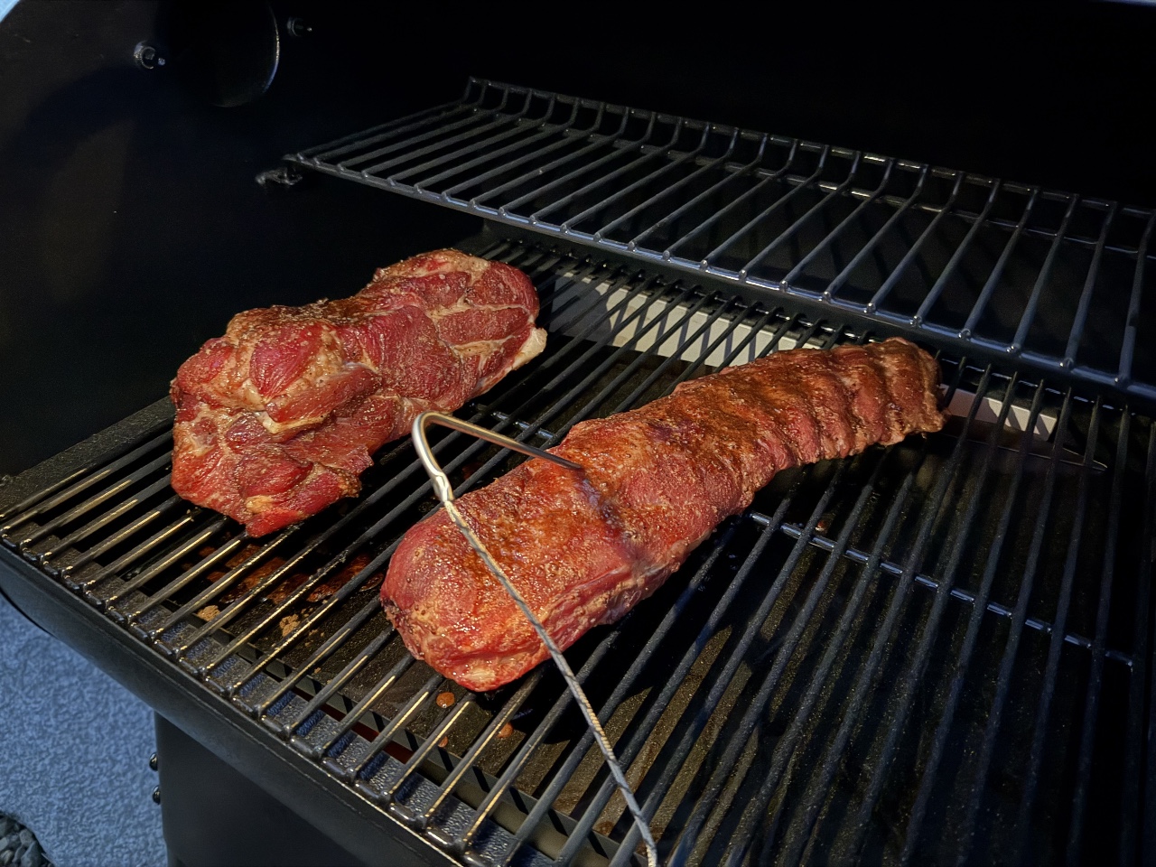 Traeger 575 Pellet Grill in use, a person grilling meat