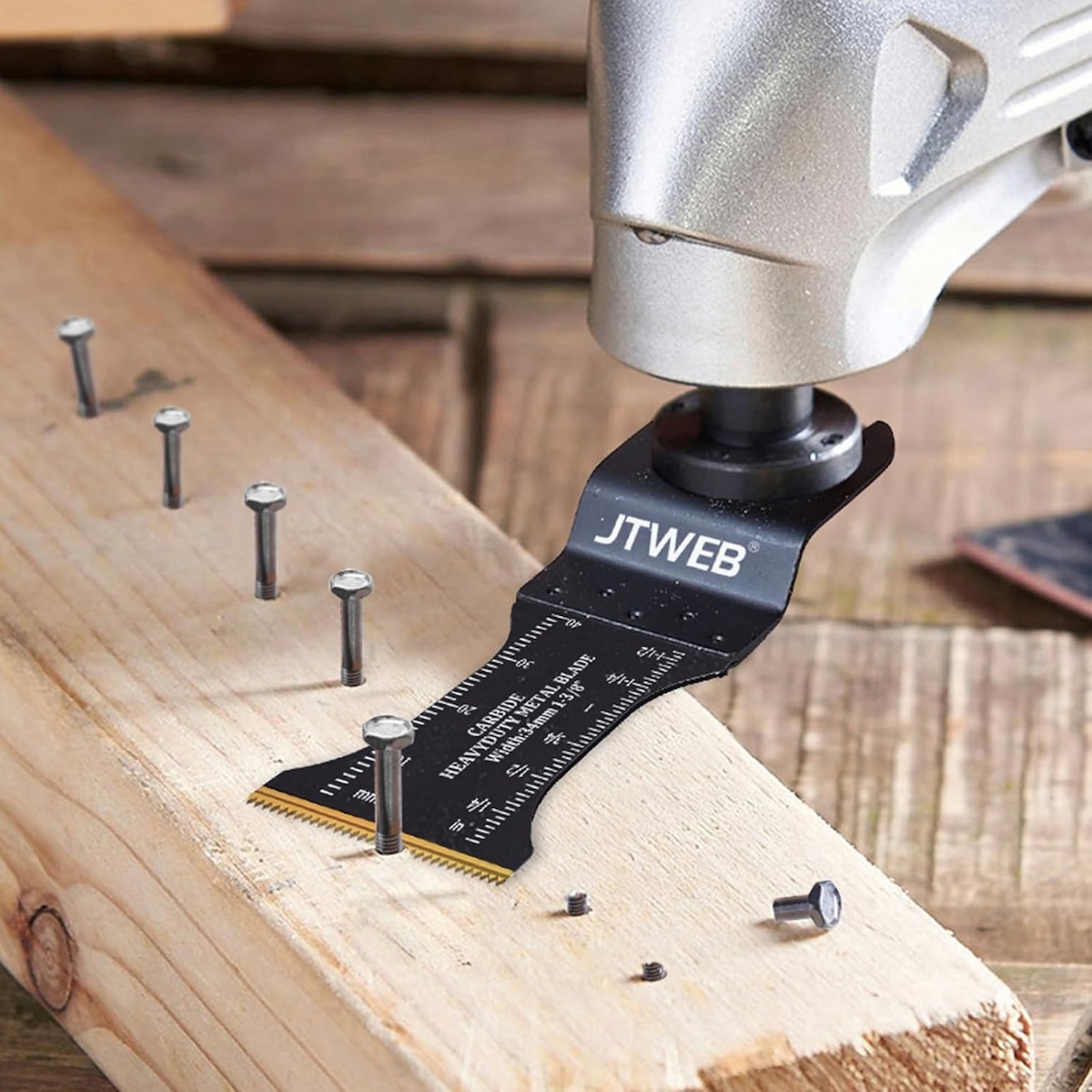 An oscillating tool cutting off bolts in a 2x4 board.