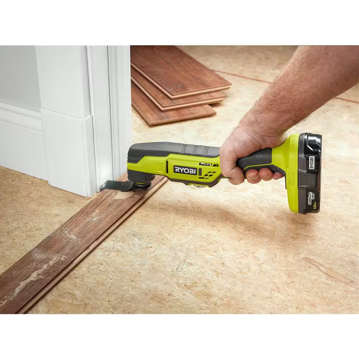 A person using an oscillating tool to cut baseboards for new flooring.