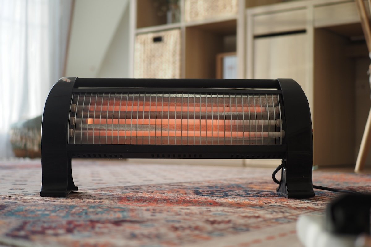 Heater is placed in the living room on a rug during cold days.