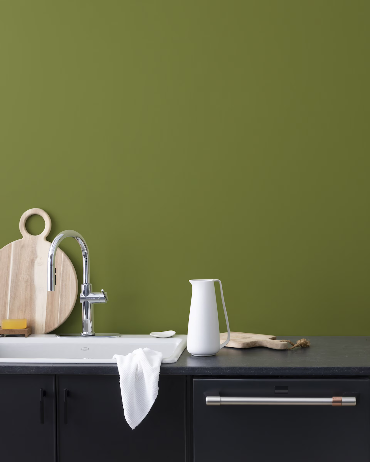 Avocado, one of the best green paint colors from Benjamin Moore, painted on a kitchen wall.