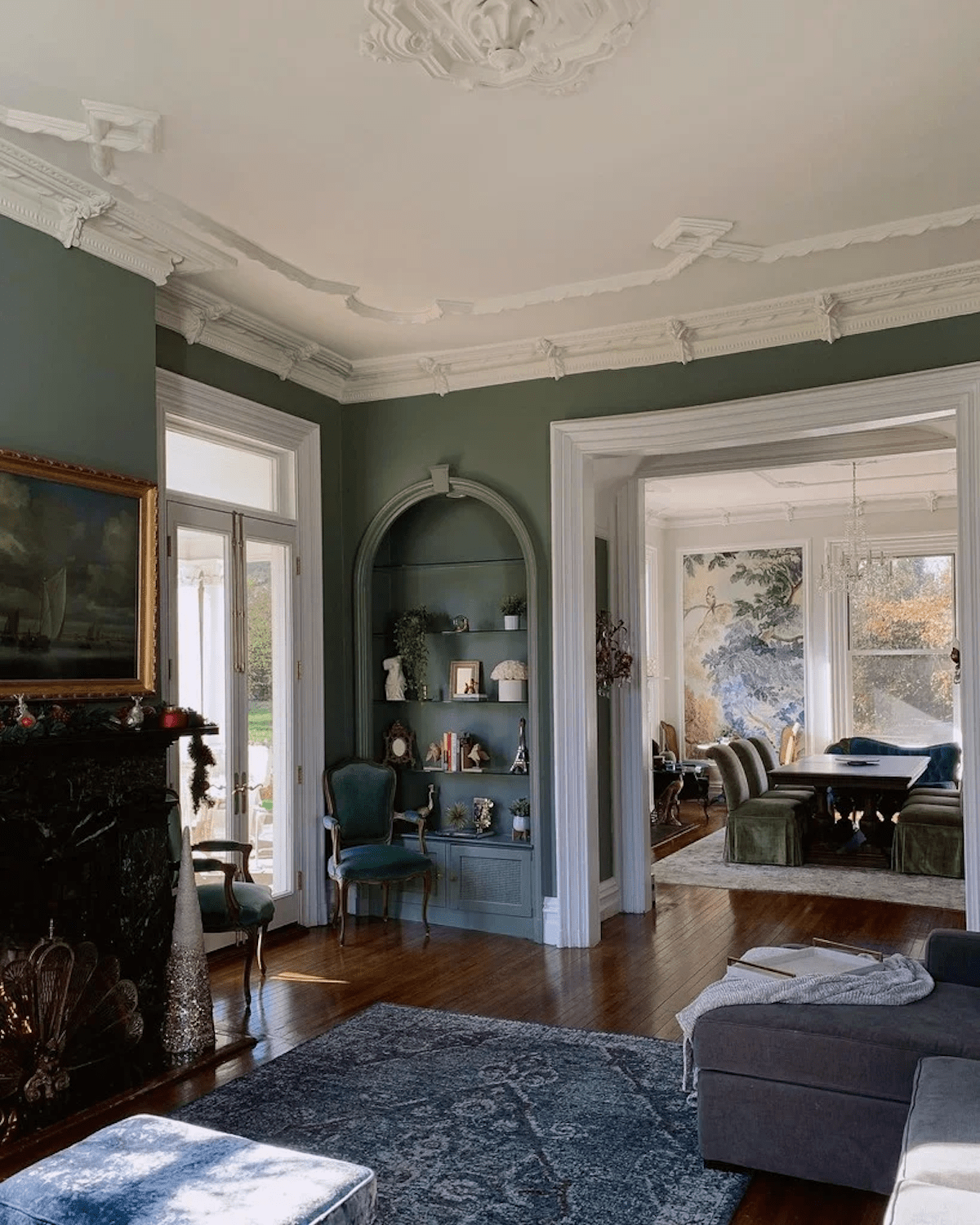 A living room painted in Green Smoke from Farrow & Ball, one of the best green paint colors.
