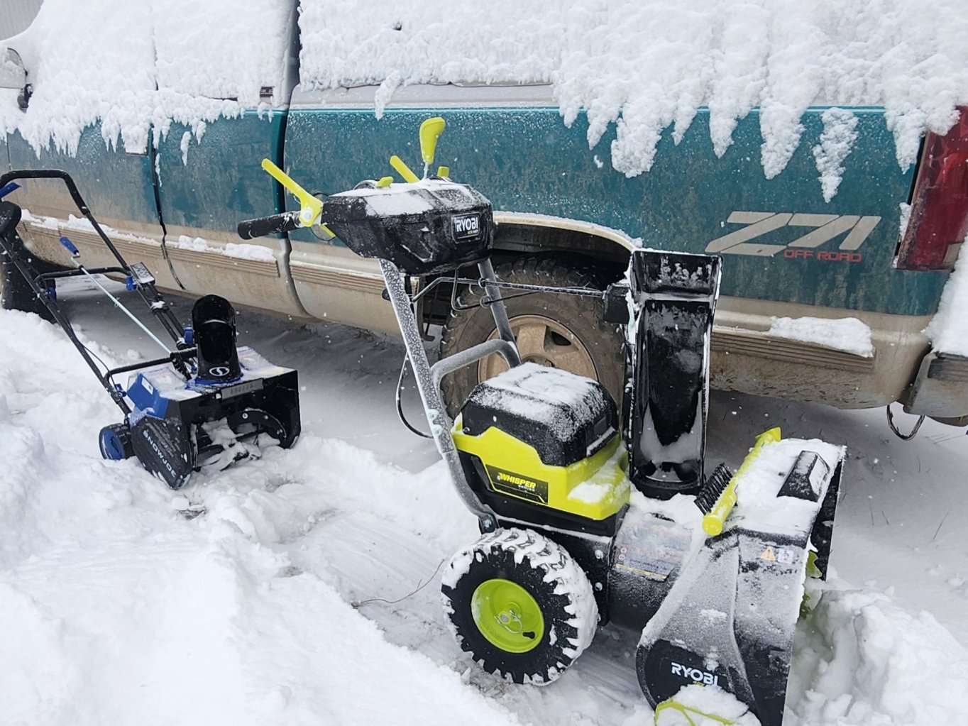 Ryobi 40V 22 Two-Stage Cordless Snow Blower presented outside next to a truck