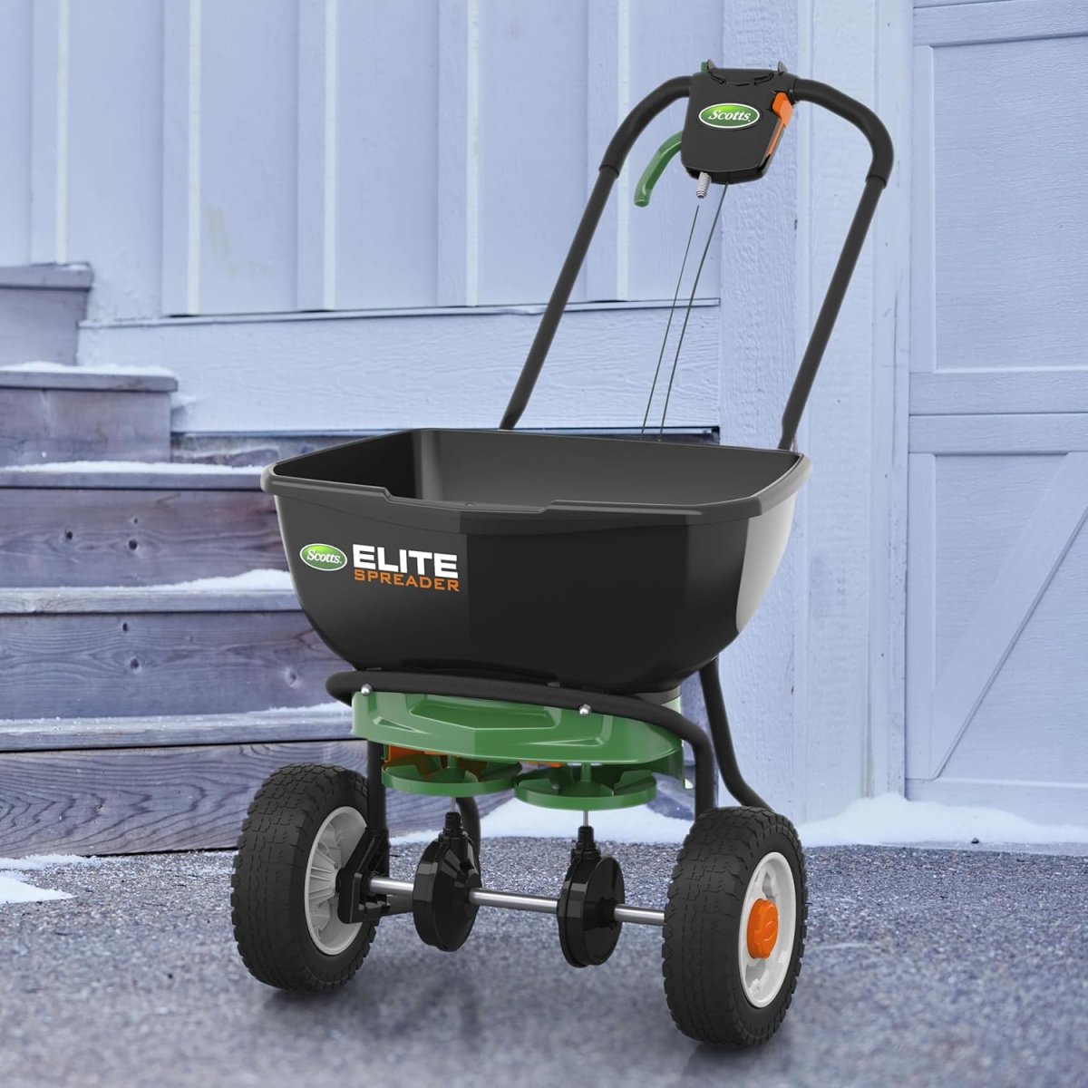 Scotts Elite Spreader holding salt for melting ice on hardscape