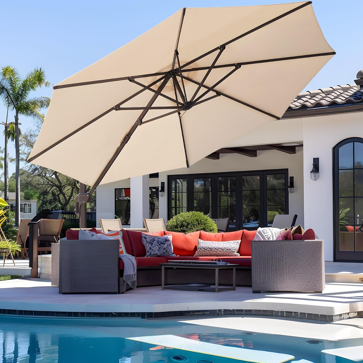 Large tan sun umbrella in backyard with pool.