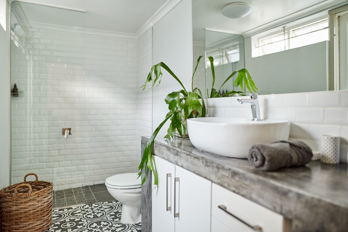 A bathroom with a solid concrete countertop.