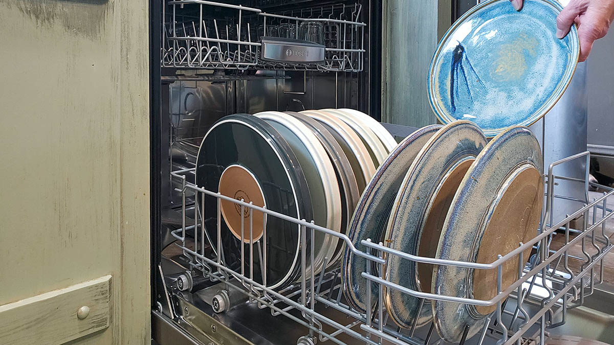 Bosch Dishwasher Review Loading a plate in the dishwasher