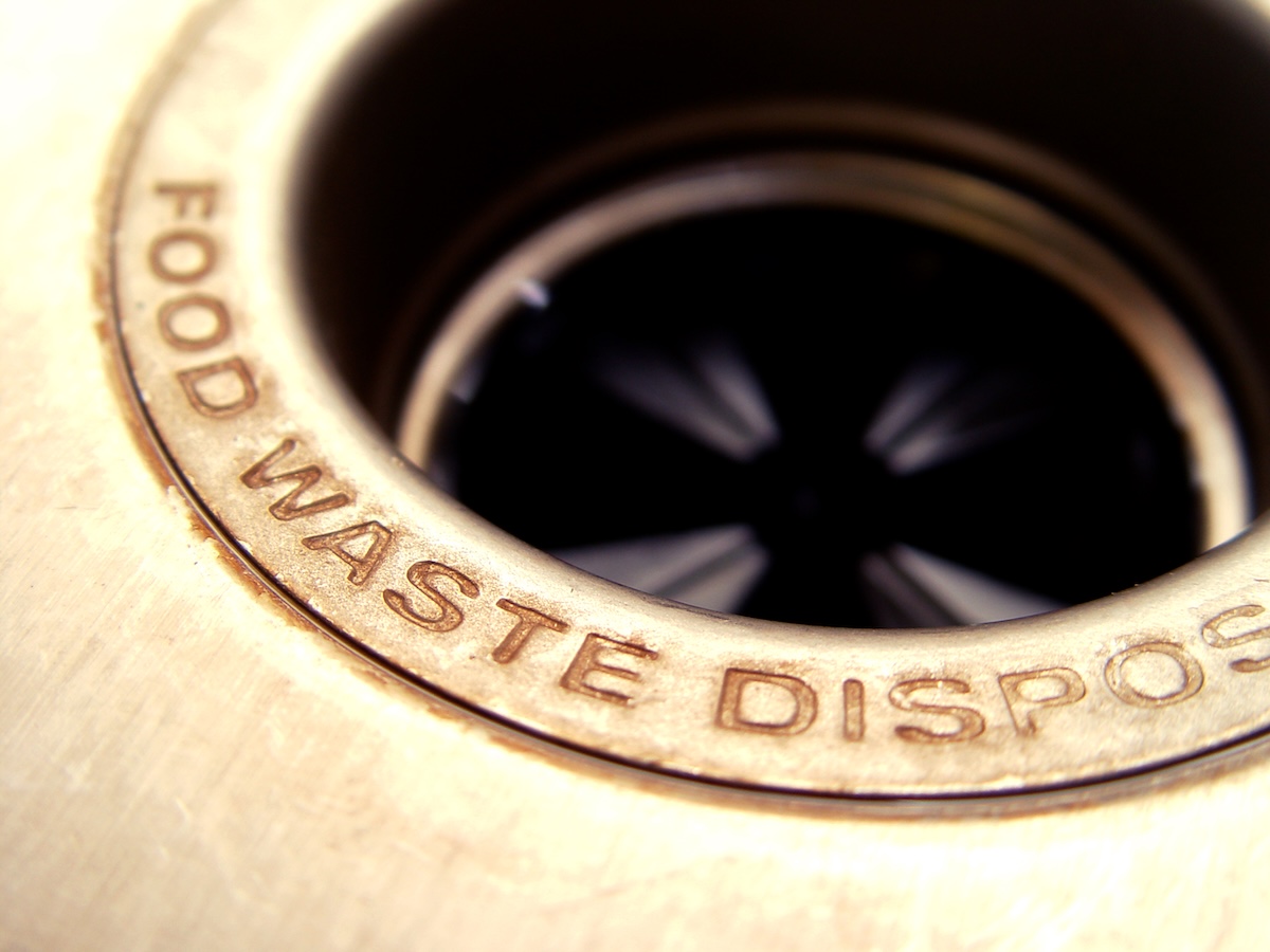 A garbage disposal drain in a kitchen sink.