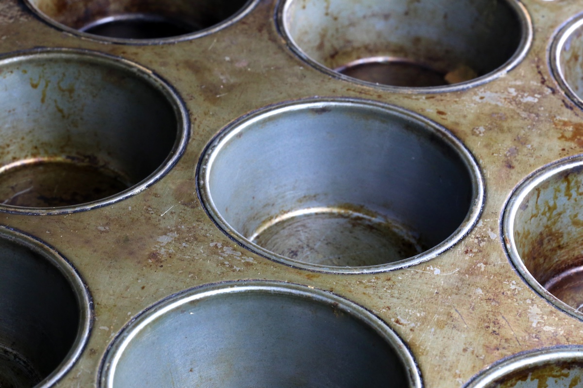 An empty silver muffin tin.