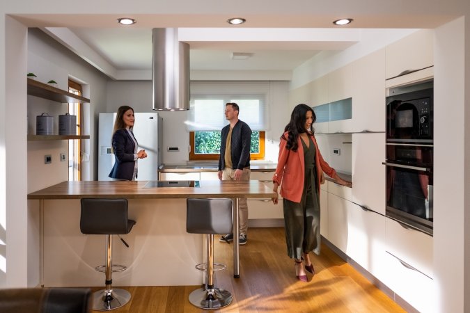 A couple viewing a home with a remodeled kitchen.