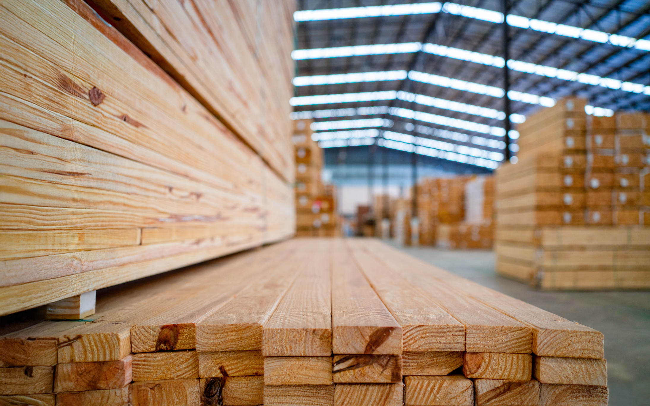 Stacked lumber in a warehouse.