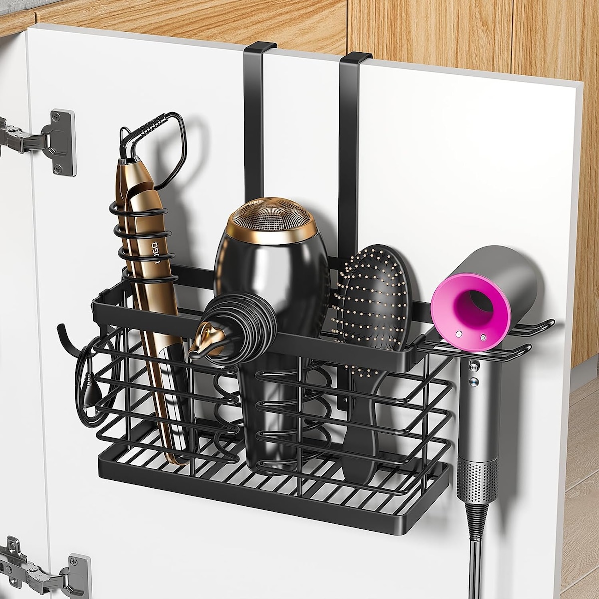 A basket hanging on the back of a cabinet door with hair tools.