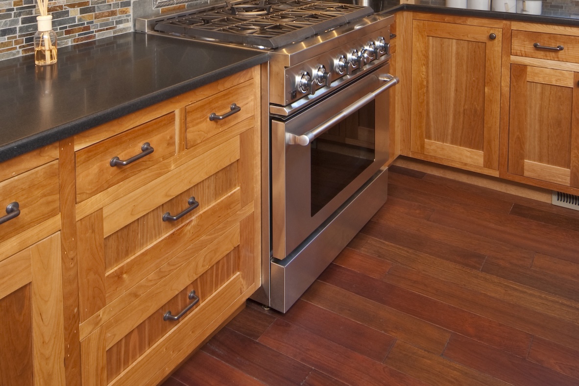 Mission-style kitchen cabinets with a dark countertop.