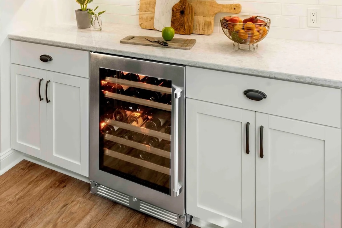 White Shaker lower cabinets with a stainless steel wine fridge between them,