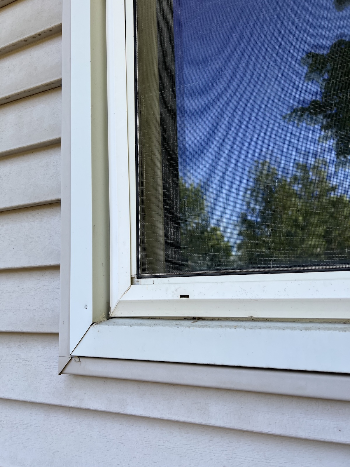 A window weep hole for drainage and moisture control.