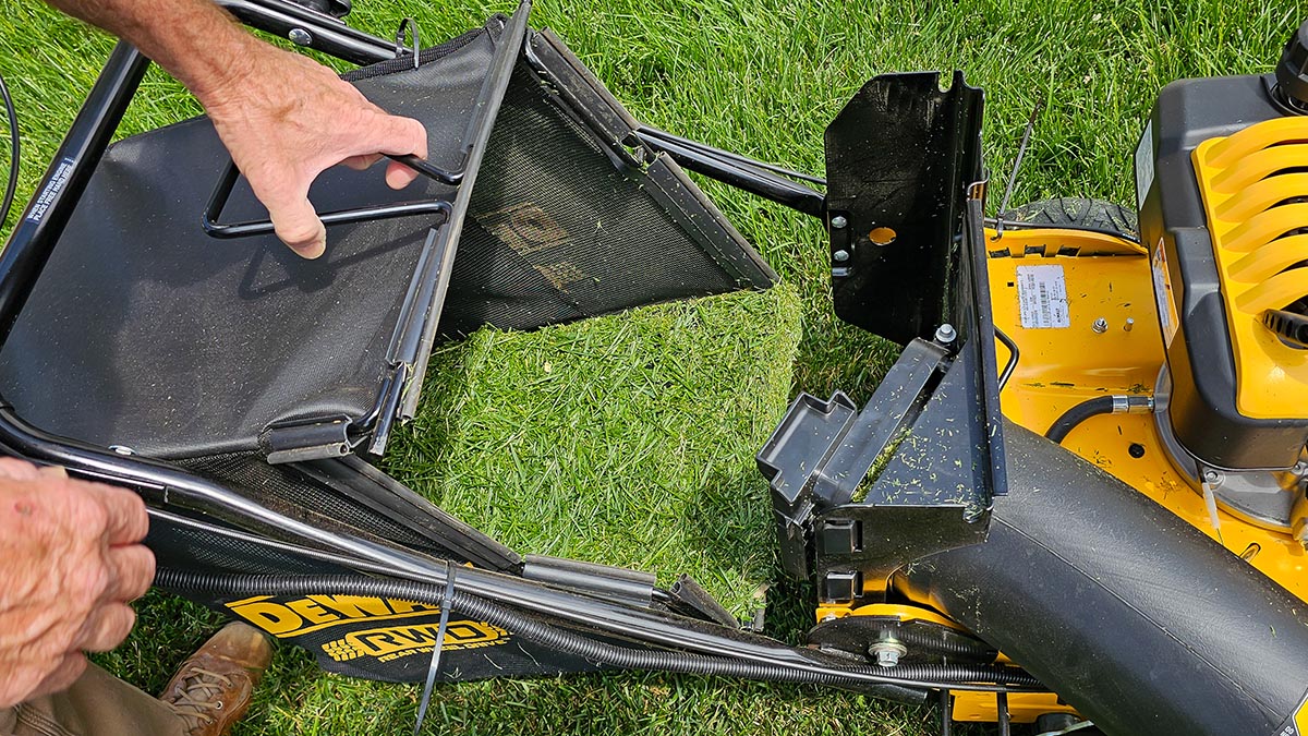 DeWalt Gas Lawn Mower Review Removing the grass clipping bag on the DeWalt mower