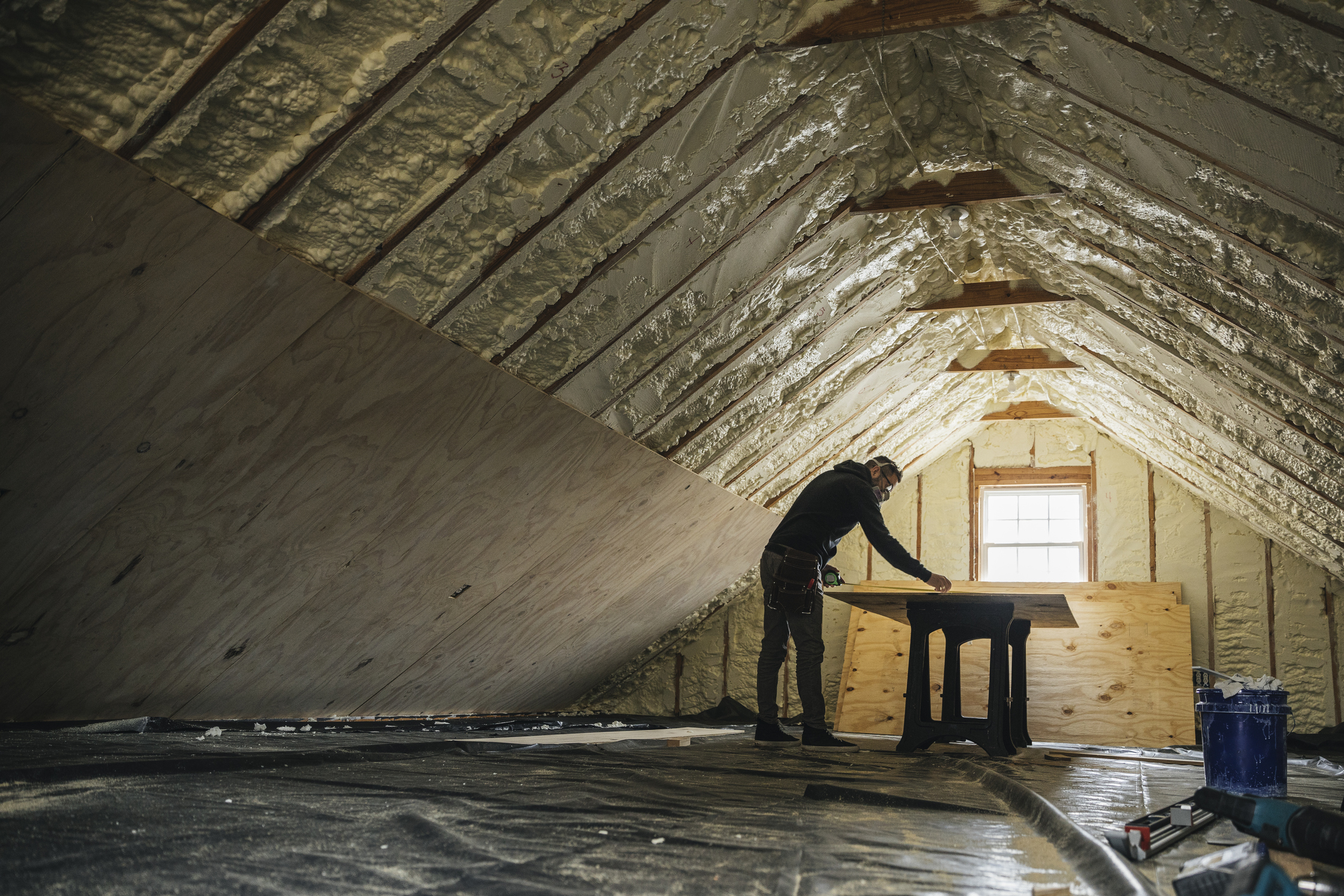 Man renovating home interior and installing insulation