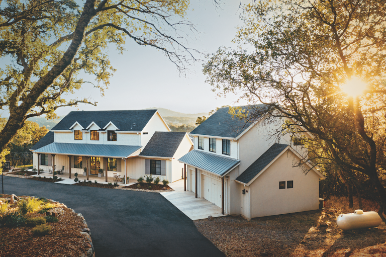 A farmhouse-style home with a propane tank outside for clean, reliable energy and backup power.