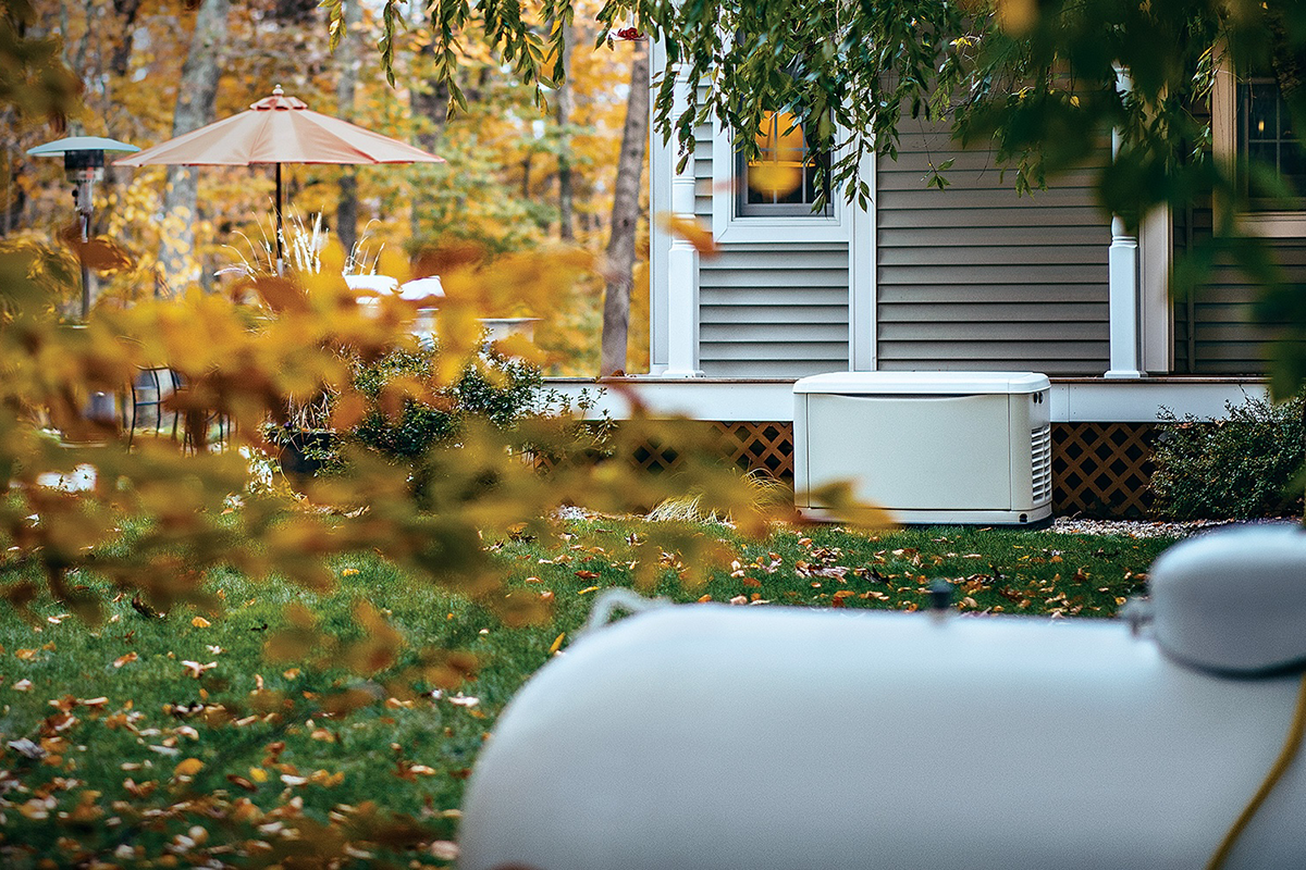 A propane tank and backup generator installed outside of a suburban home.
