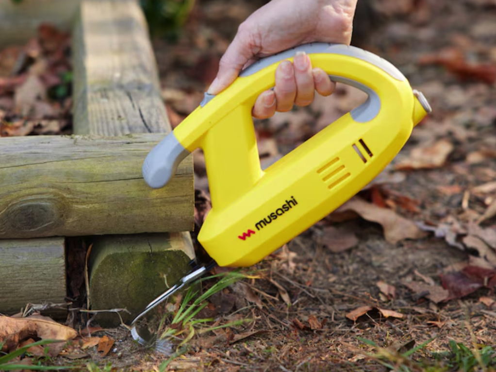 Weeding tool in use that is 80% off deal at Lowe's