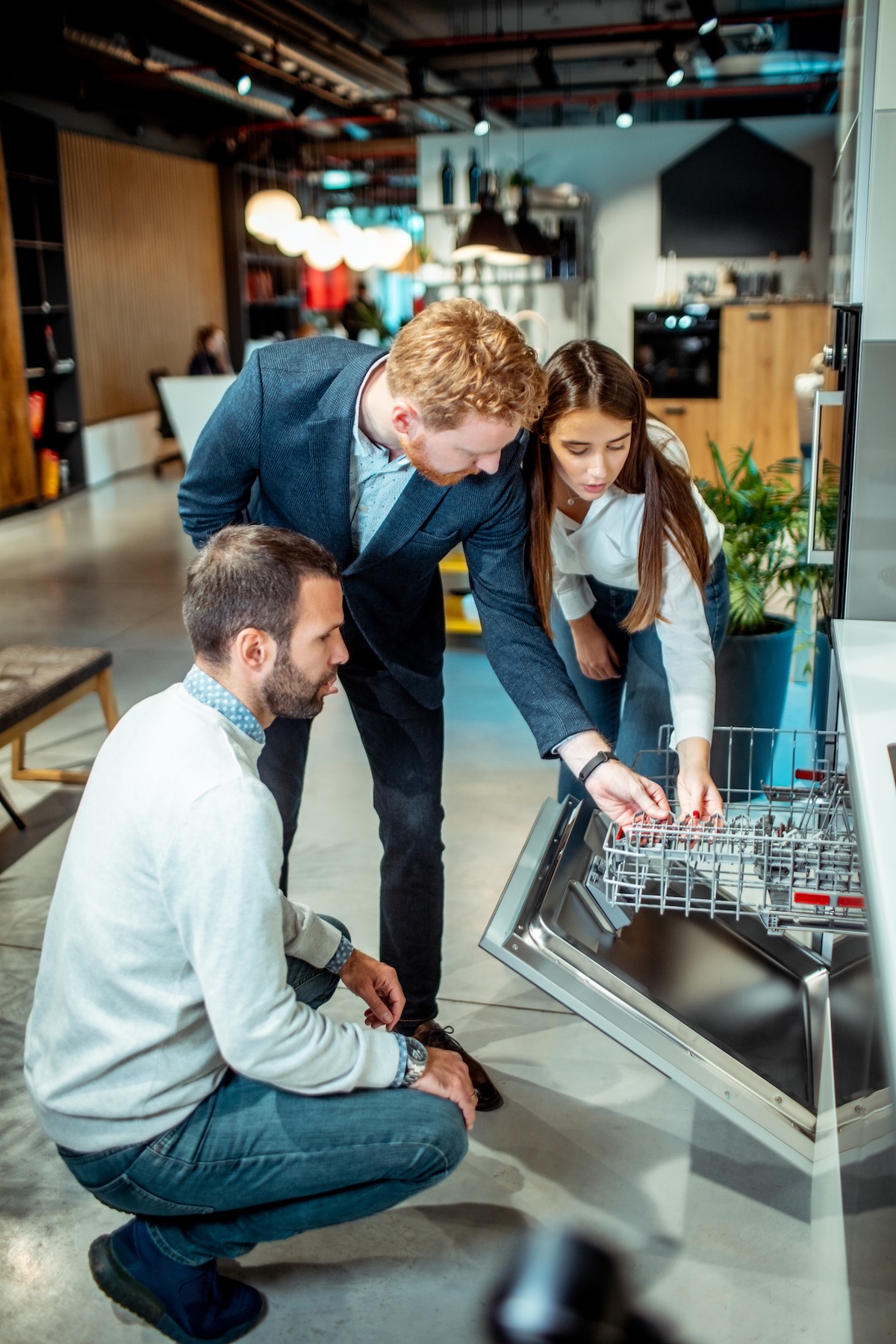 Couple shopping for a new dishwasher at an appliance store.