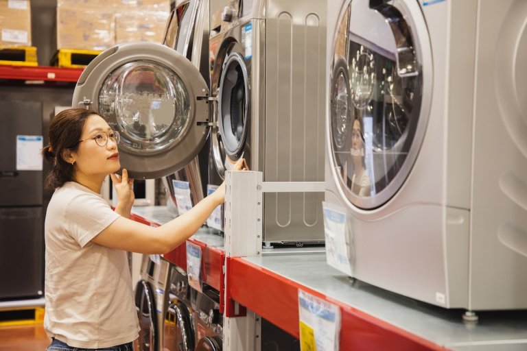 A person shopping for energy efficient appliances and washing machines.