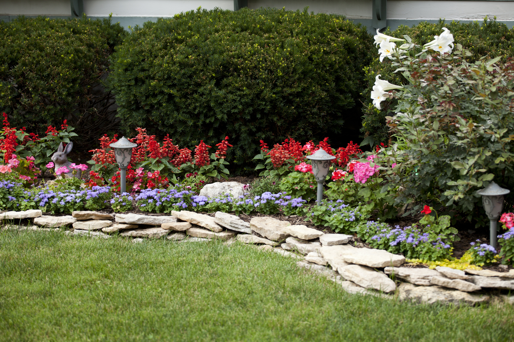 Beautiful flower garden with limestone retaining walls and outdoor garden lights