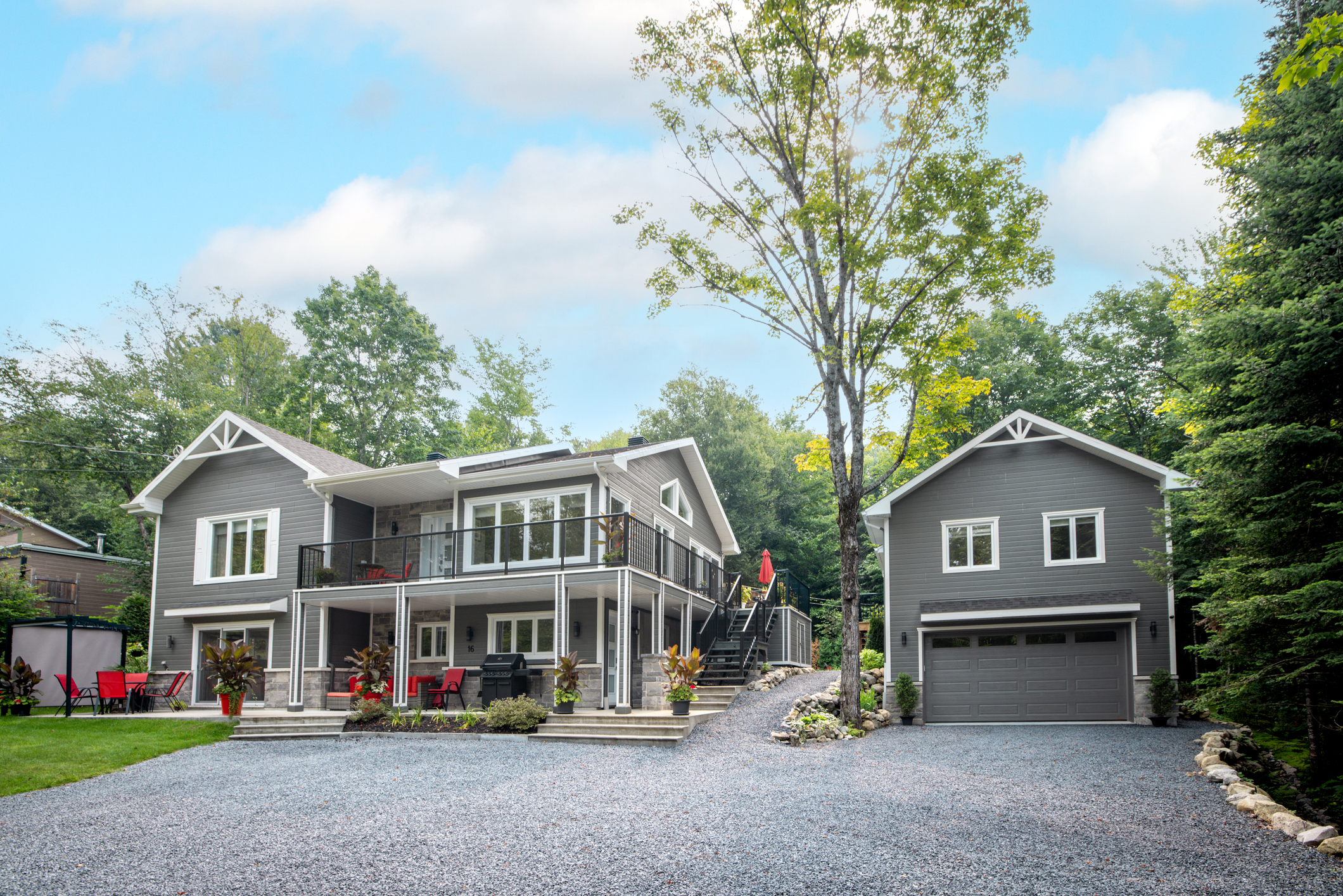 Gray and white house with detached garage located in Quebec