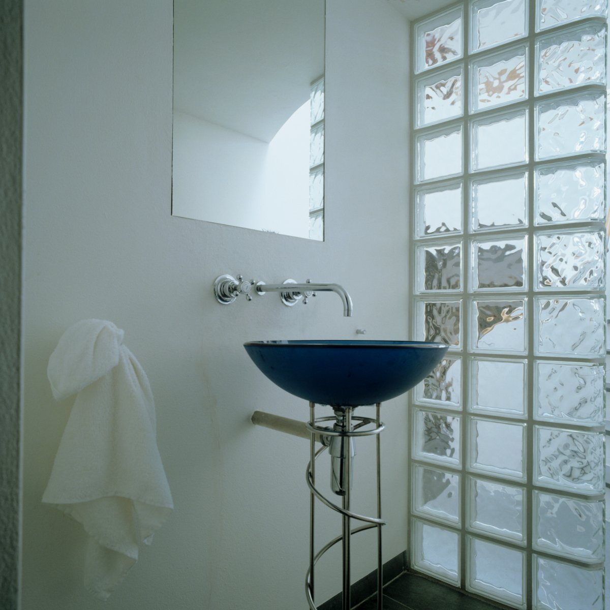 Bathroom featuring a glass block wall.