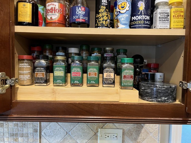 Inside of organized cabinet with bamboo spice rack
