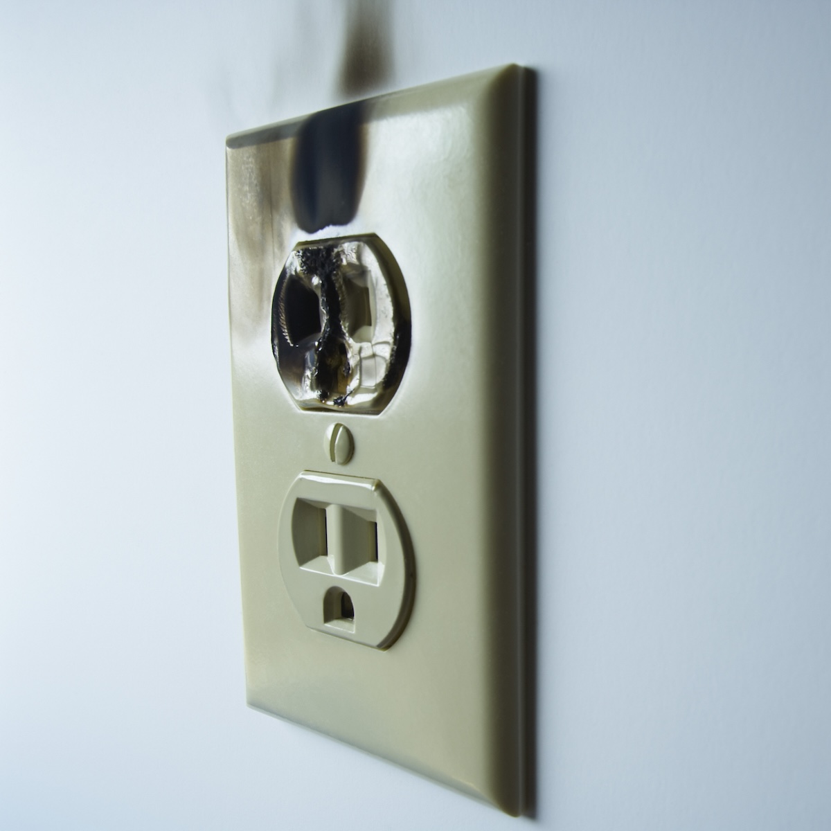 An electrical outlet with burn marks.