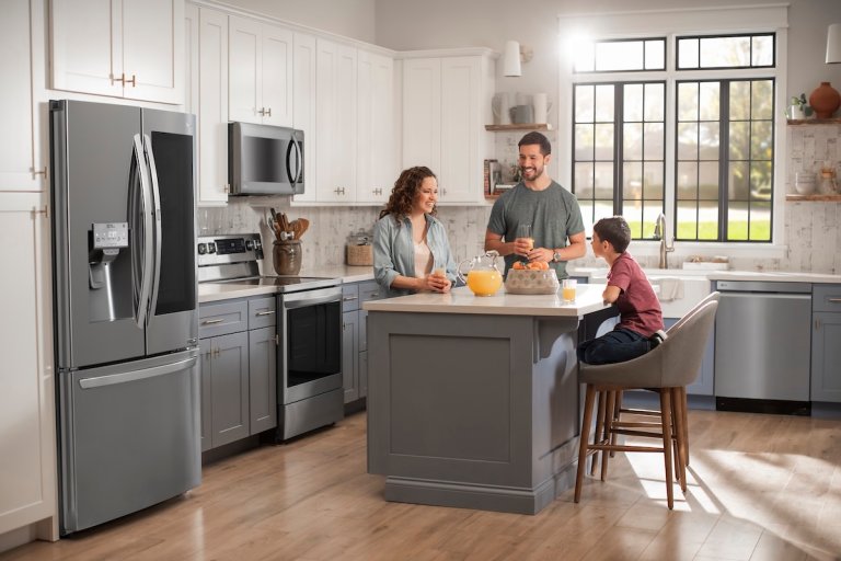 Family gathered in the kitchen with AI appliances that make life easier.