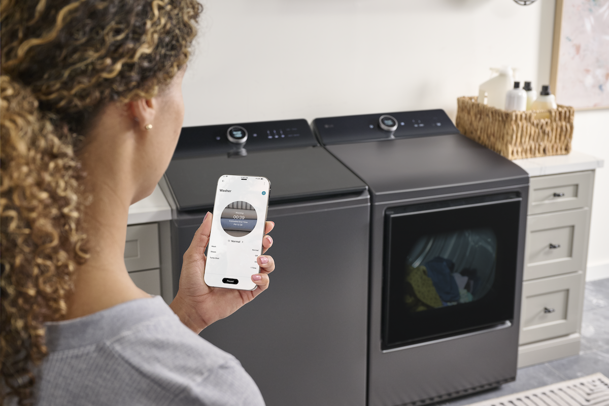 A homeowner using LG's ThinQ platform equipped with AI to manage laundry machines.