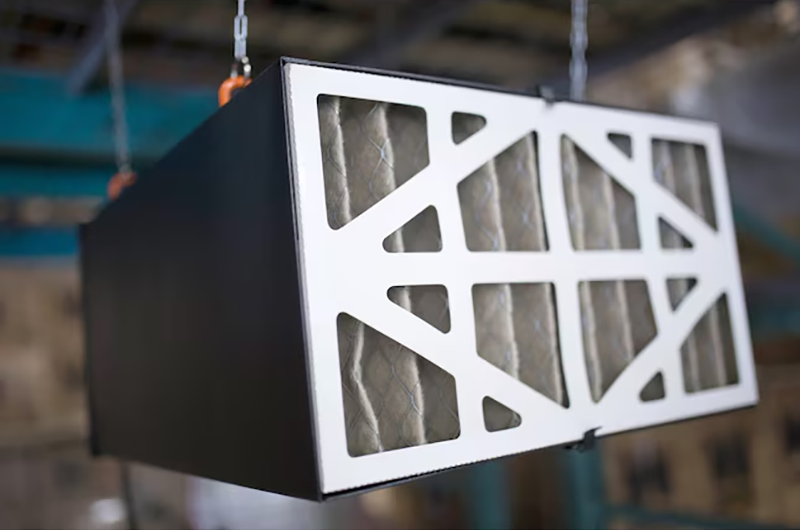 A ceiling air purifier mounted in a garage workshop.