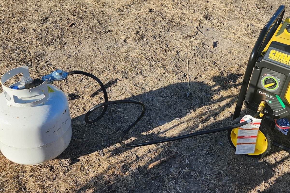 Propane tank attached to a yellow and black portable Champion generator.
