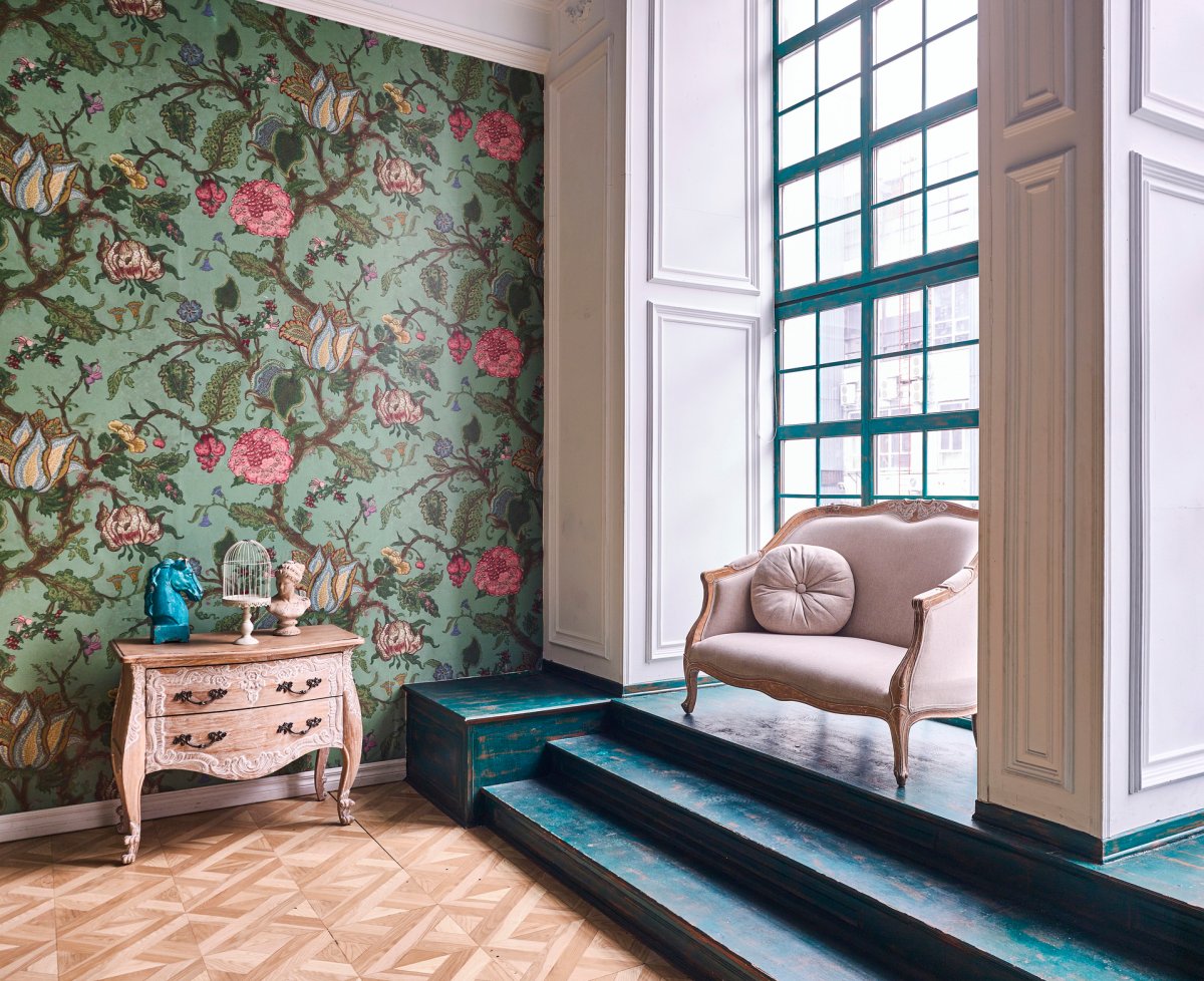 Green floral wallpaper on one wall in a room.
